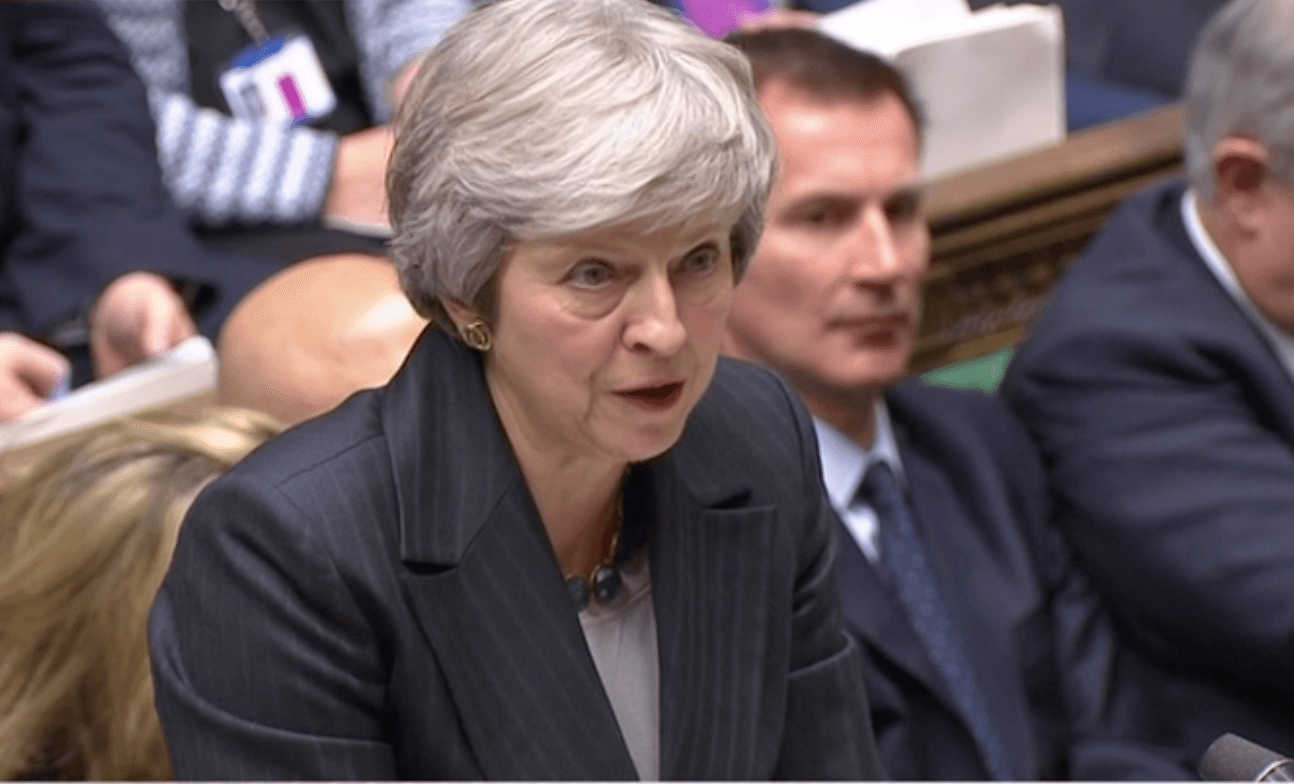 May fights on and defends her deal