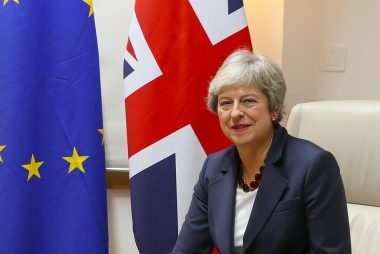 May in front of flags